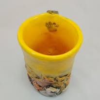 Yellow ceramic mug with animal carvings