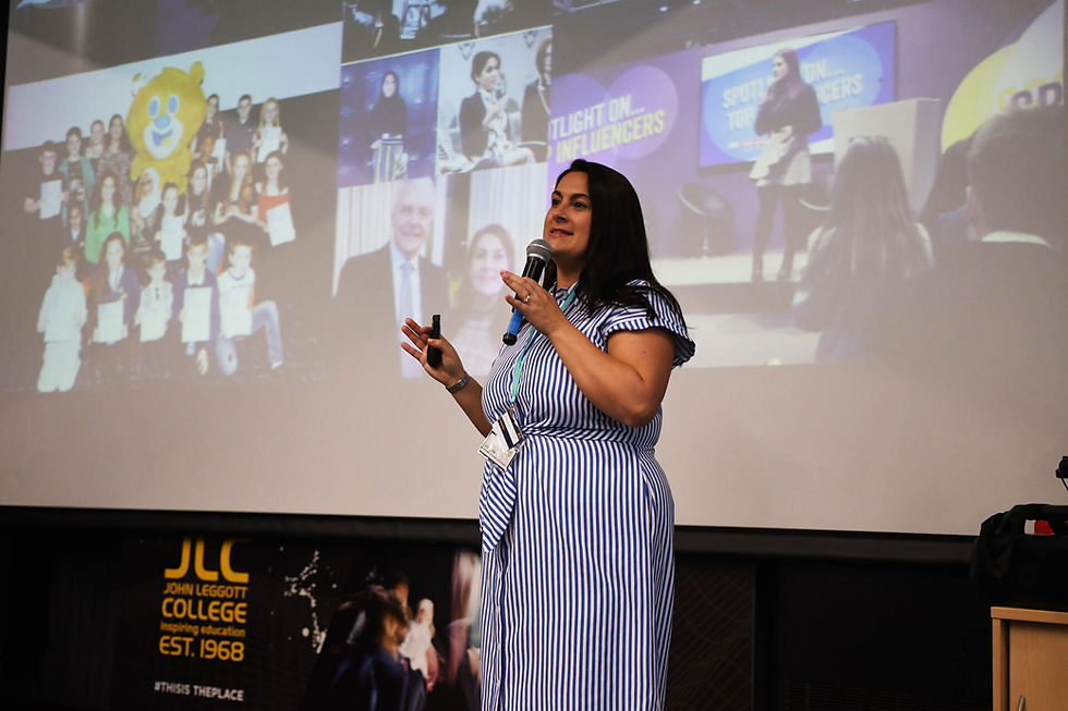 A group of women from the JLC women in leadership event standing in front of the JLC backdrop