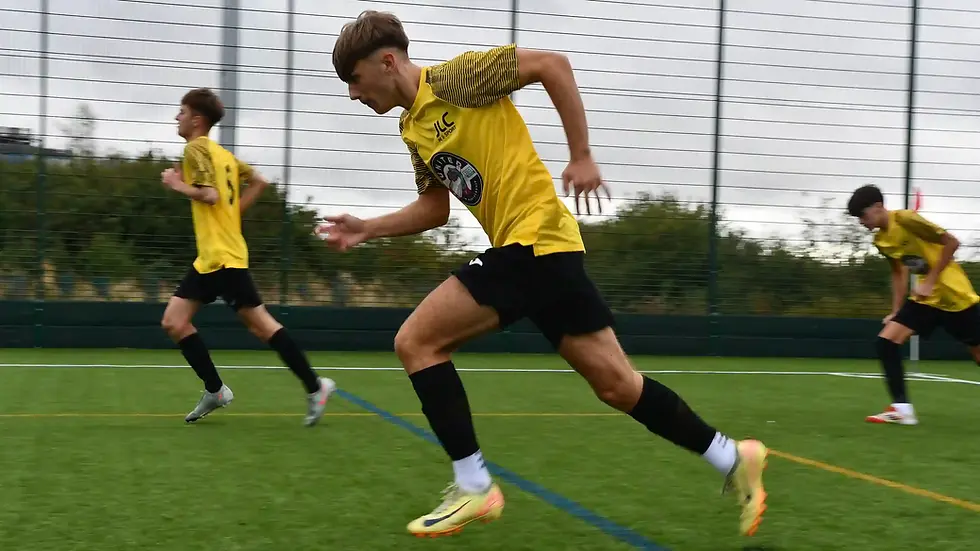 A John Leggott College student runs across the 3G pitch during a football match wearing the United in Partnership kit