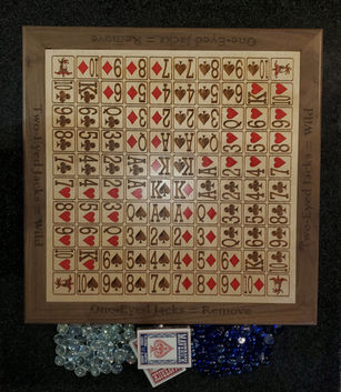 Sequence game board with lasered, hand colored card faces on baltic birch. Solid walnut frame.   Includes cards and glass playing pieces.

Approximately 20" x 20" 
 
$120