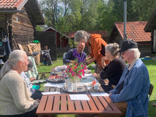 Människor vid fika bord på Bastberget fäbod
