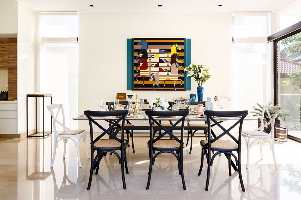 The dining room’s centrepiece is another Hermes scarf that plays up the equestrian theme of this area