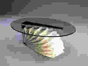 the prototype table comes in two variations: Statuario marble, an elegant white marble with black veins, and Black forest, a black marble with meandering white streaks. The supporting C-shape stainless steel structure features a choice of either gold; champagne gold, rose gold or bronze finish and the glass top can be either grey or bronze tinted to complement the colours of the marble selected for the base.