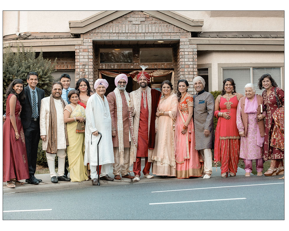 group shot of grooms family outside the house