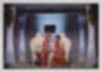 Husband and wife sit on the ceremonial chairs after Hindu ceremony