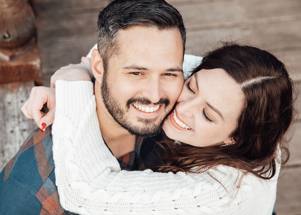 girl and guy from above, they both smile as she hugs him tight