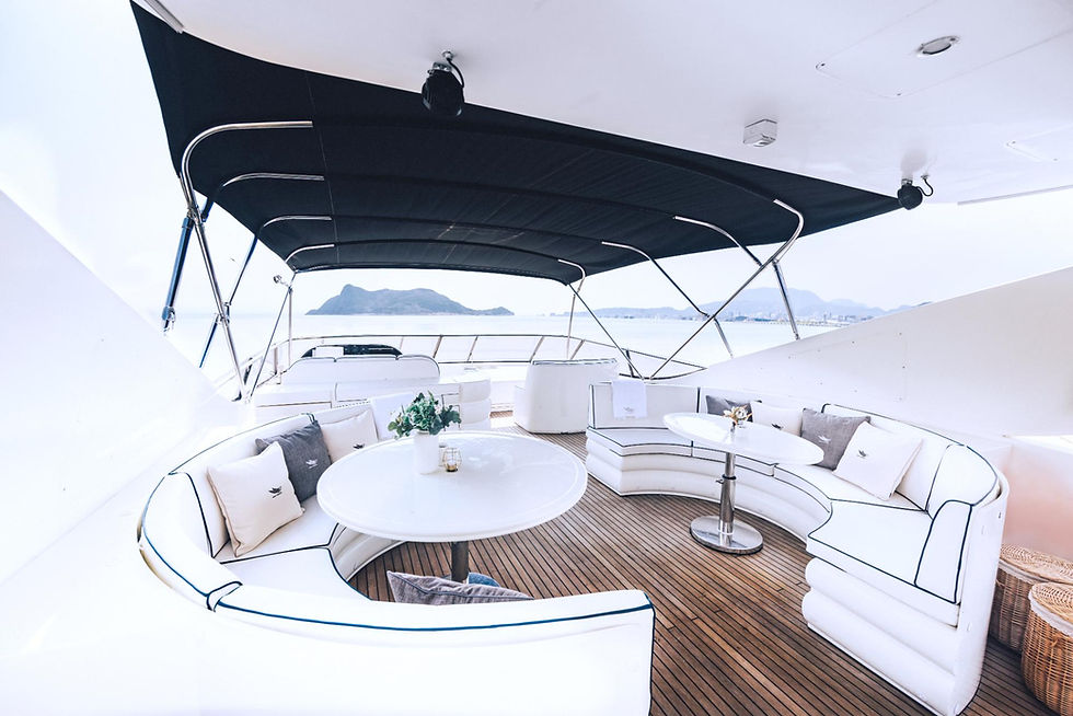 Yacht deck with white curved seating and tables