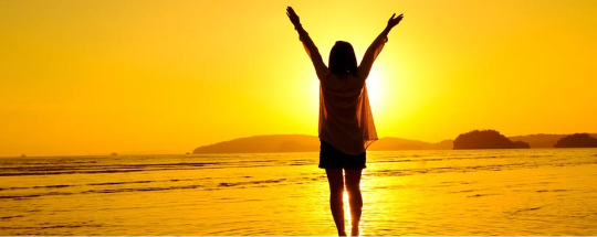 A happy girl on the sea shore.