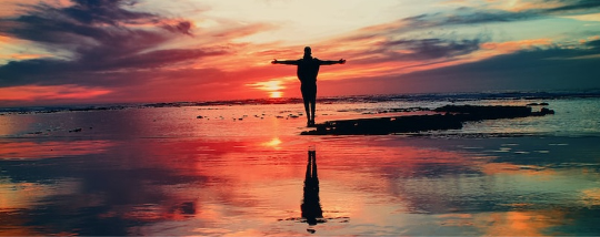 A person standing at the beach.