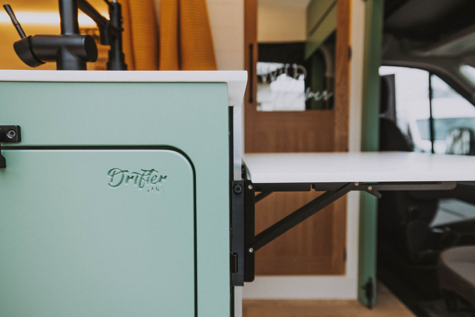 Flip-up countertop extended. Aurora Magnolia solid surface, Nomadik kitchen zone, Ford Transit Extended, Drifter.