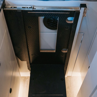 Pullout bed step stowed flush, Sidewalk Gray cabinet front, Drifter Scout layout Ford Transit Extended.
