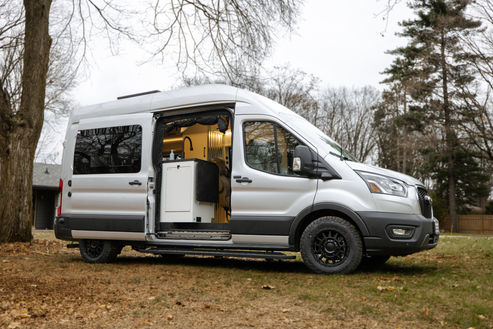 Ford Transit camper van exterior with side door open.