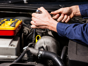Mans hand working on an engine