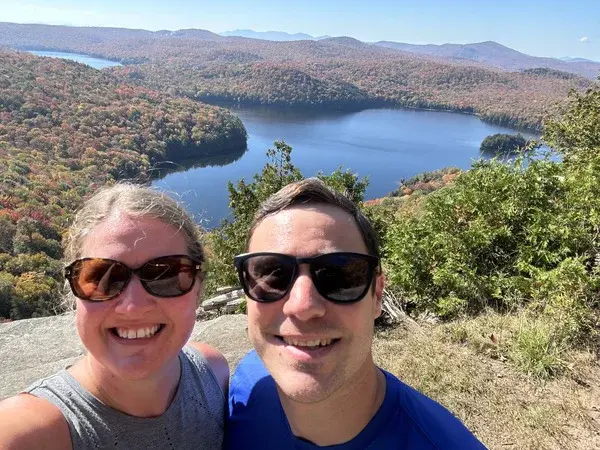 Mallory and Matt taking a selfie with a spectacular natural view in the background, capturing their vanlife adventure.