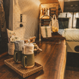 Sparrow Peak live edge countertop in Drifter Class B campervan No. 01/24, silver overmount sink and faucet.