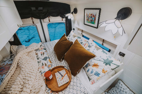 Queen 60-inch bed platform, Alabaster painted door bed wall, Ford Transit Extended Nomadik.