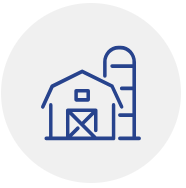 Blue line icon of a barn and silo in a circle