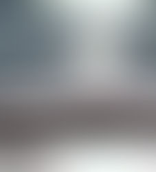 Ocean waves crash on a sunlit beach. The sparkling water reflects bright sunlight, creating a tranquil and shimmering scene.