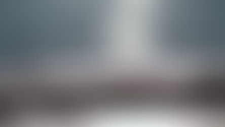 Ocean waves crash on a sunlit beach. The sparkling water reflects bright sunlight, creating a tranquil and shimmering scene.