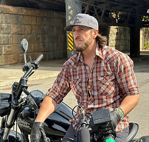 Joshua-Clark-Gymfea-Productions-Sitting-on-Harley-Davidson.png