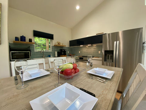 "Fully equipped modern kitchen and open-concept dining area designed for preparing and enjoying summer meals".