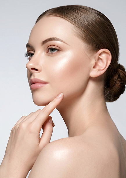 Woman with radiant, smooth skin showcasing aesthetic laser treatment results