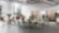 Layout Studio conference table with 10 olive green Zeph task chairs. Striad lounge seating and Bevel sofa in the background