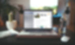 Image of a laptop on a desktop with the screen showing an open marketing emailon the screen.