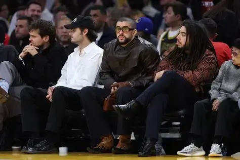 Bad Bunny (Middle) Sitting Courtside