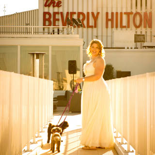 Wedding bride holding her Dog at Wedding The Beverly Hilton Hotel. Pet photography at weddings. Los Angeles Wedding Photographer. GoShiggyGo Shiggy