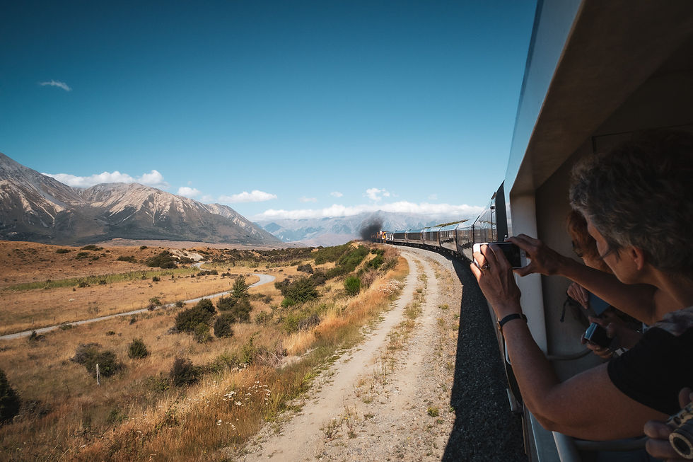 Crossing New Zealand by train – the TranzAlpine’s dramatic mountain scenery in atmospheric travel shots.