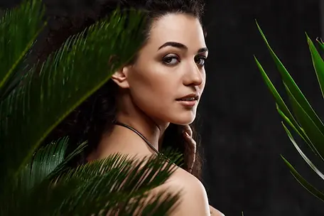 young-beautiful-brunette-girl-tropical-plants-grey-wall-1536x1024.webp