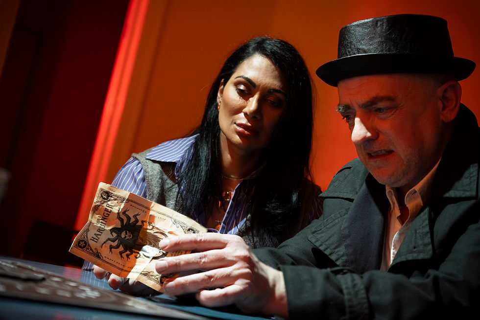 Julia (Sothcott) and Neal (Tony Sands) consider one of the Harbinger's cards.