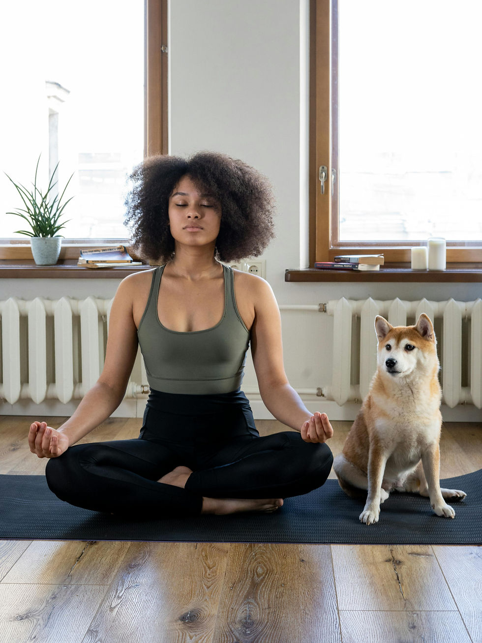 woman doing calming yoga at home with dog