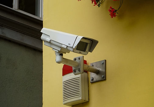 white and gray security camera mounted o