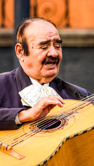traditional mariachi man playing guitar mexico city