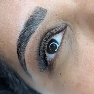 Close-up of laminated brows on dark skin client.