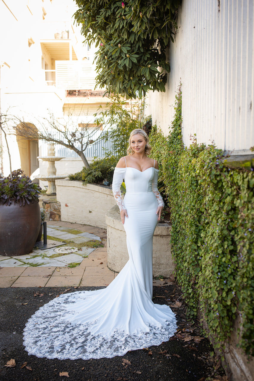 Front view of the ‘The Rest of My Life’ fitted crepe gown by Jean Fox with sweetheart and lace off-the-shoulder sleeves