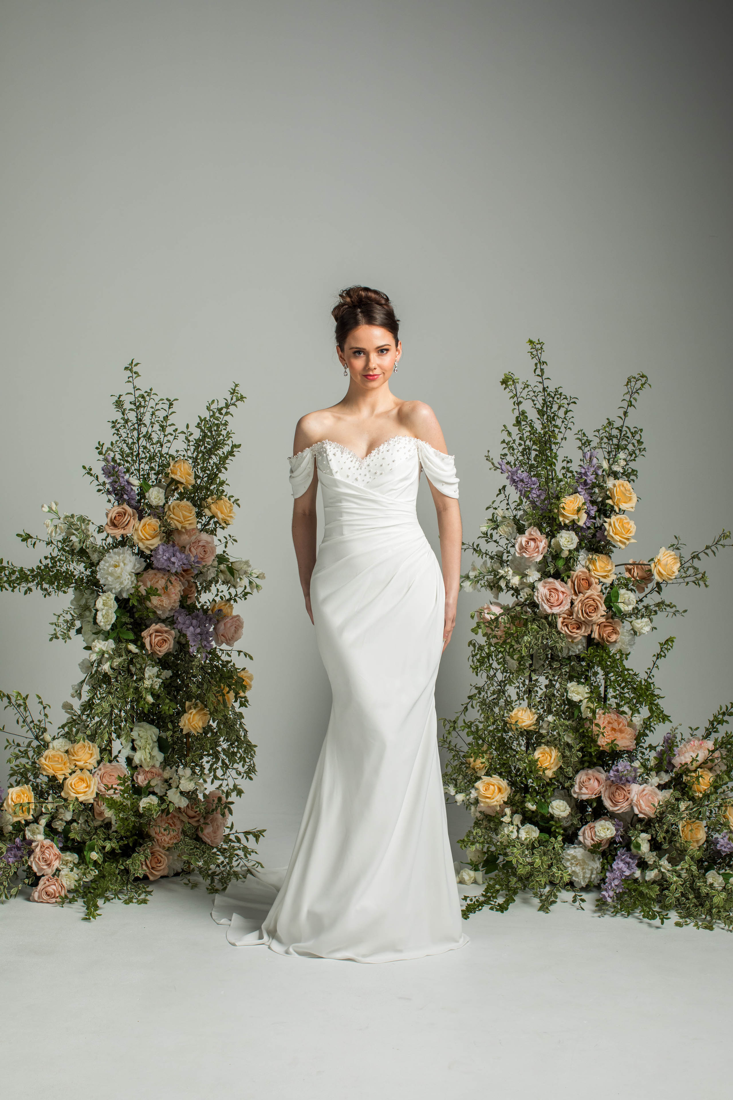 'and so it goes' J235 by Jean Fox, fitted crepe gown with off-the-shoulder design and front draping, front view