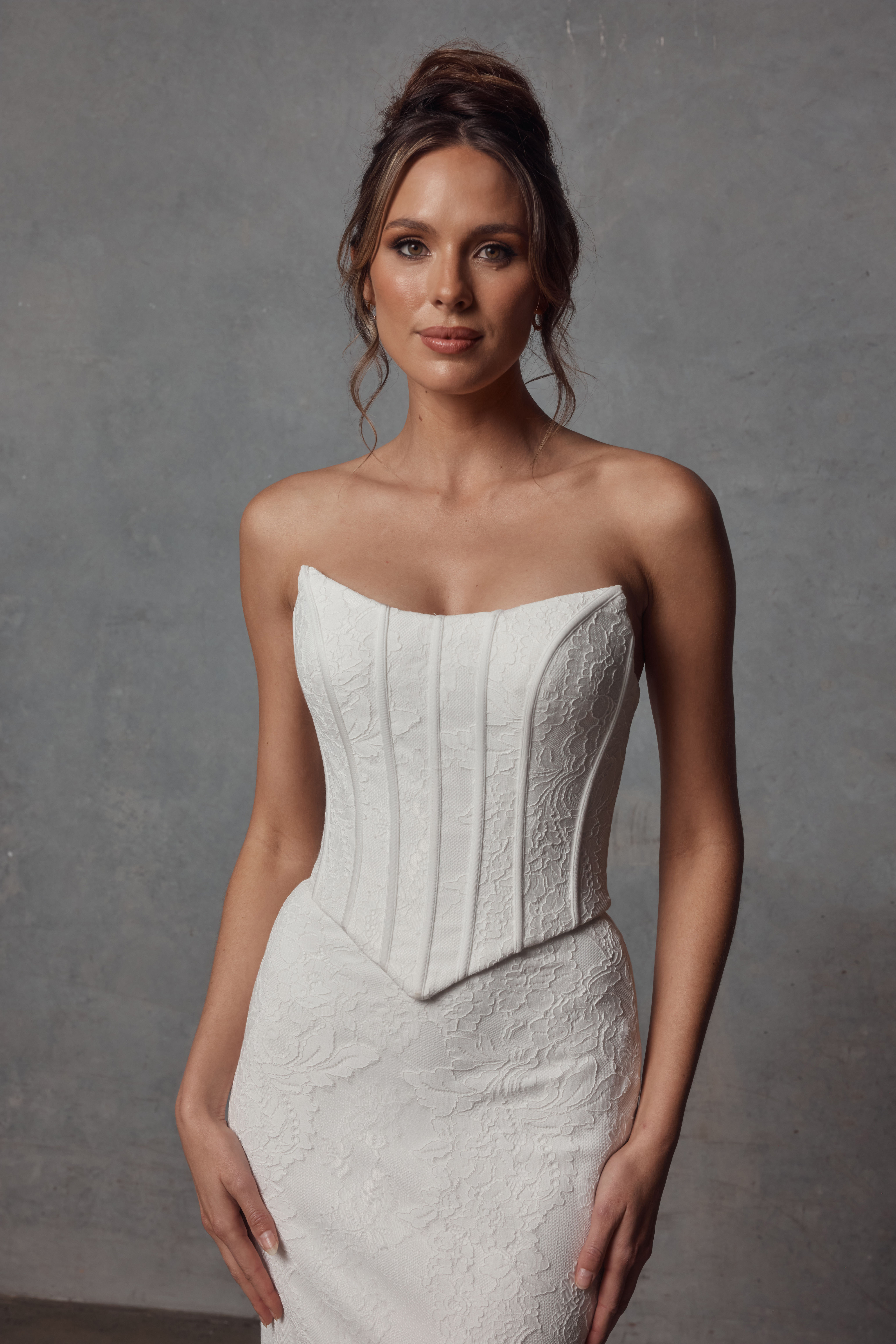 Front view of ‘Morgan Bodice’ by Jack Sullivan Bridal with exposed boning and lace detail