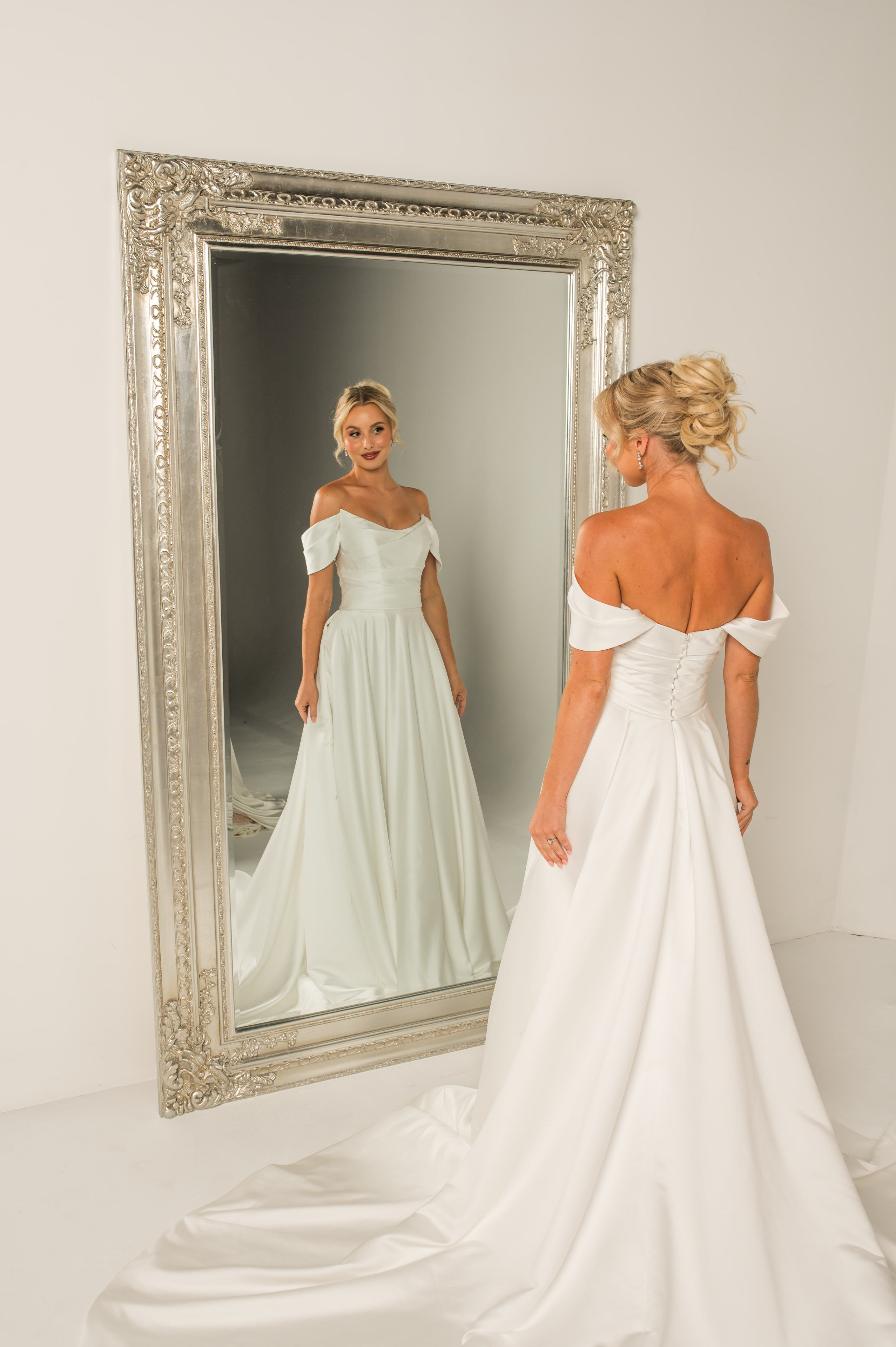 Satin A-line gown with pleated bodice, scoop cat-eye neckline, and off-shoulder straps