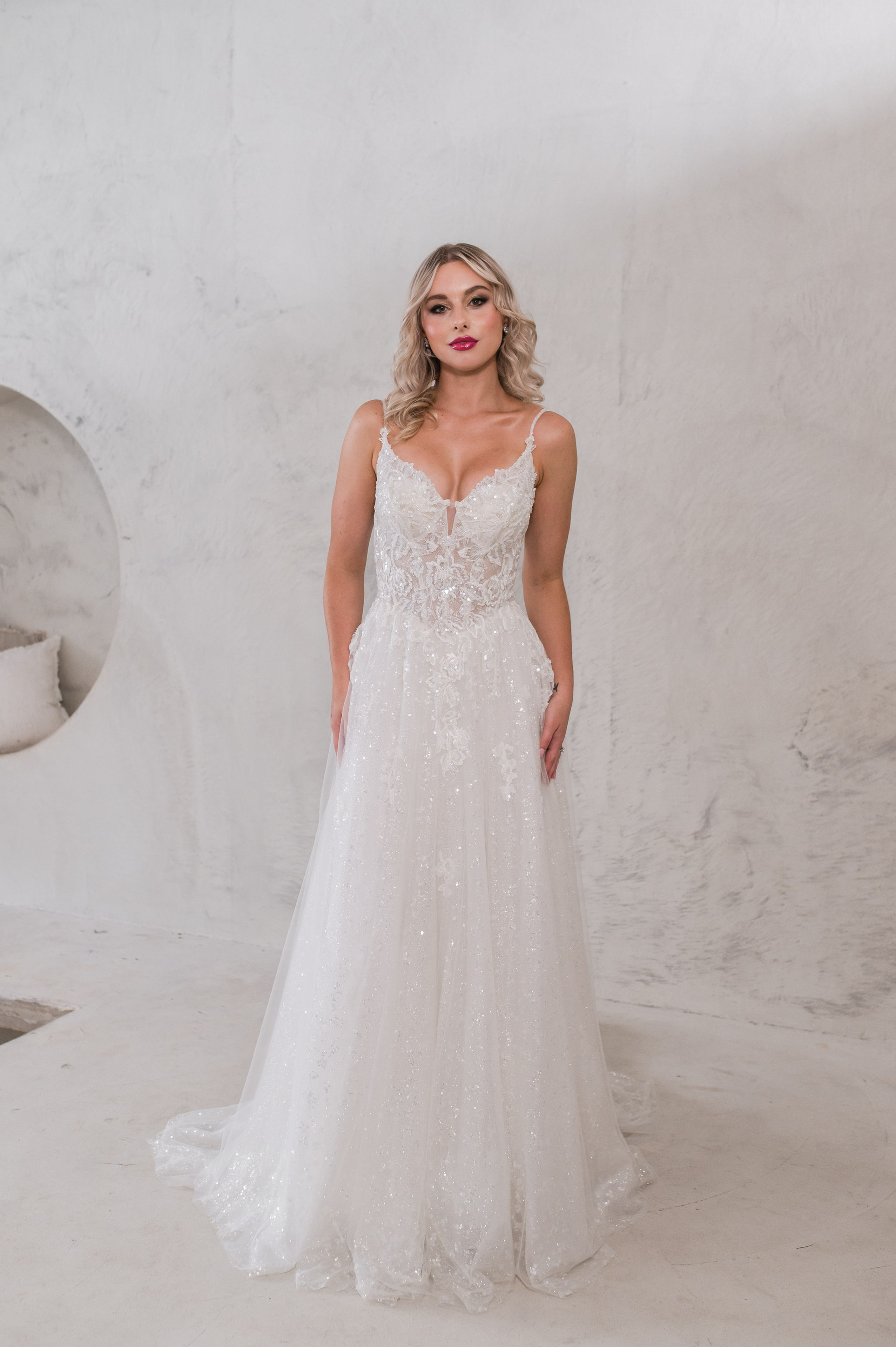 Front view: A-line wedding dress with deep V neckline and beaded lace bodice