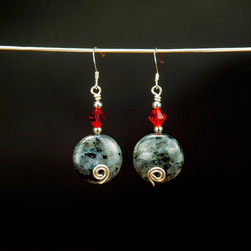 Gray labradorite earrings with a ruby red accent bead. These earrings have a small silver swirl near the bottom of the stone