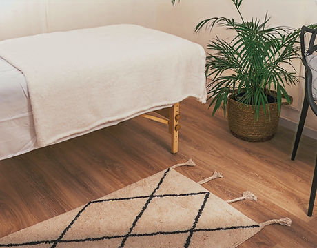 Massage table in a room announcing ability to book online