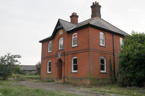 Shows red brick farmhouse before restoration
