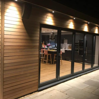 Garden room with cladded external walls with light shining downwards