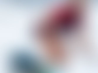 Sup racer in waves wearing a red and blue jersey