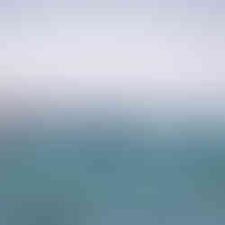 choppy blue seas with SUP race