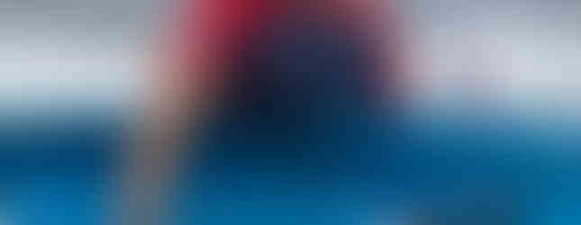 SUP Racer on the beach with their blue board