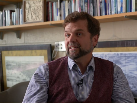 Cinematic documentary wide shot of a university researcher in Pennsylvania with natural warm lighting